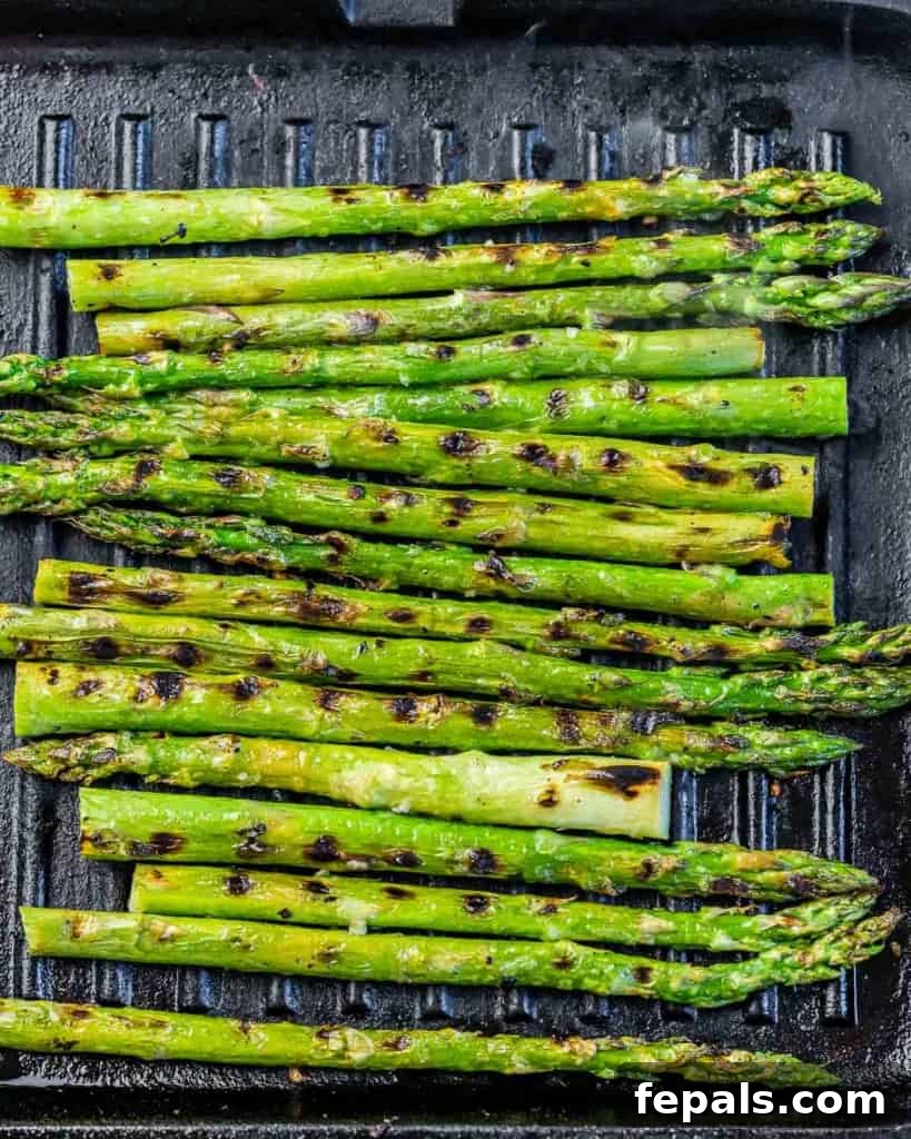 Charred Asparagus with Zesty Lemon-Garlic 7 Asparagus cooking on a grill pan.