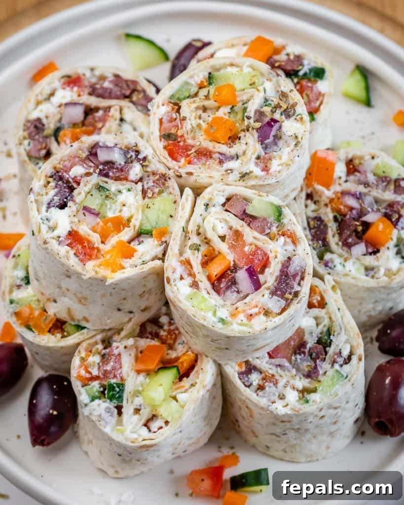 Savory Vegetable Spirals 9 Top view of Veggie Pinwheels arranged on a white serving plate, garnished with fresh herbs, ready to be enjoyed.