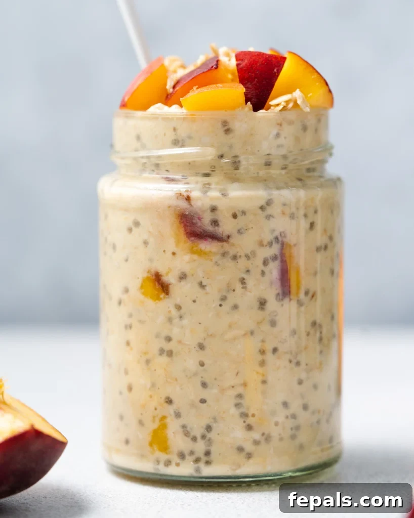 Velvet Peach Dream Oats 14 side shot of jar with overnight oats topped with peaches