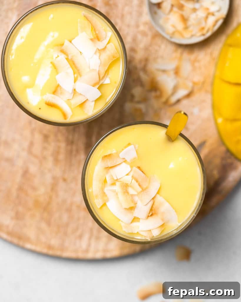 Tropical Mango Delight 3 Mango smoothies topped with coconut flakes.