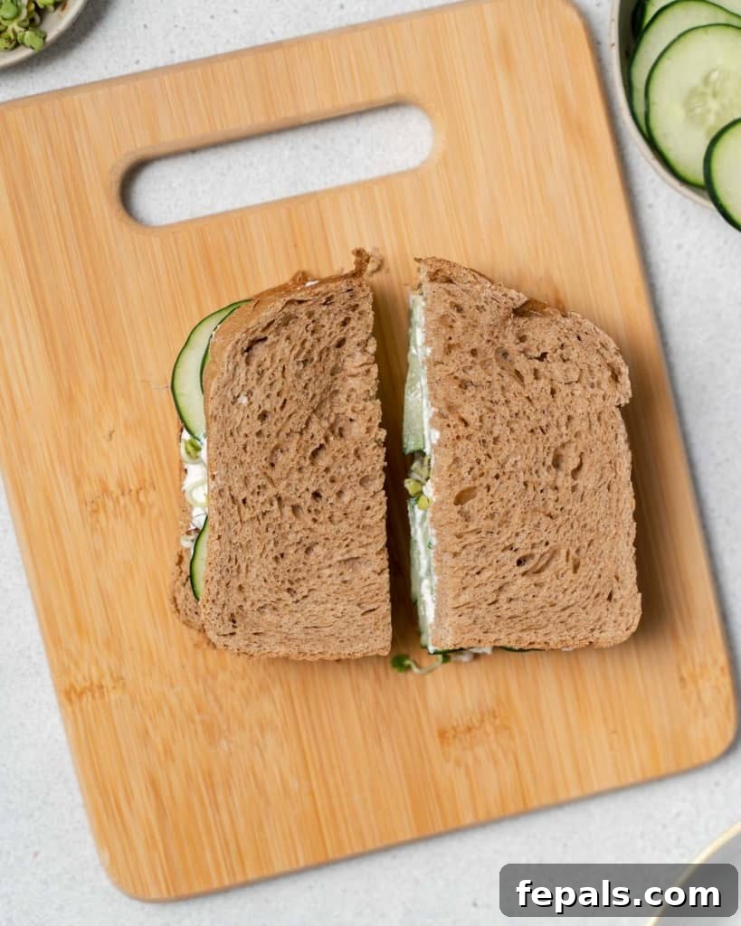 Elegant Cucumber Delights 11 Cutting a cucumber sandwich in half.