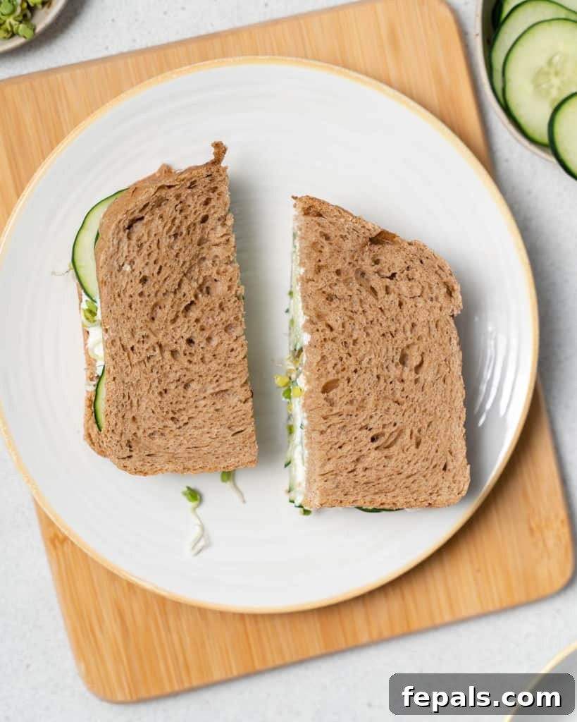 Elegant Cucumber Delights 12 Serving a cucumber sandwich on a white plate.