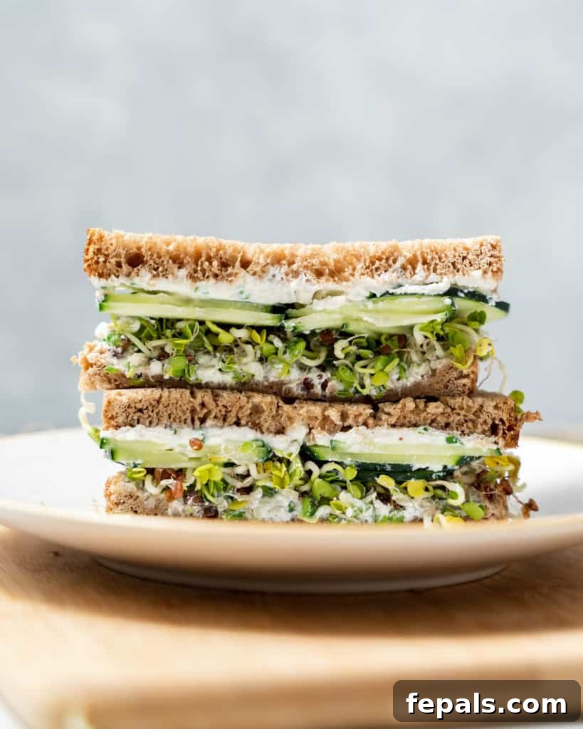 Elegant Cucumber Delights 14 side shot of sandwich halfs stacked on a plate
