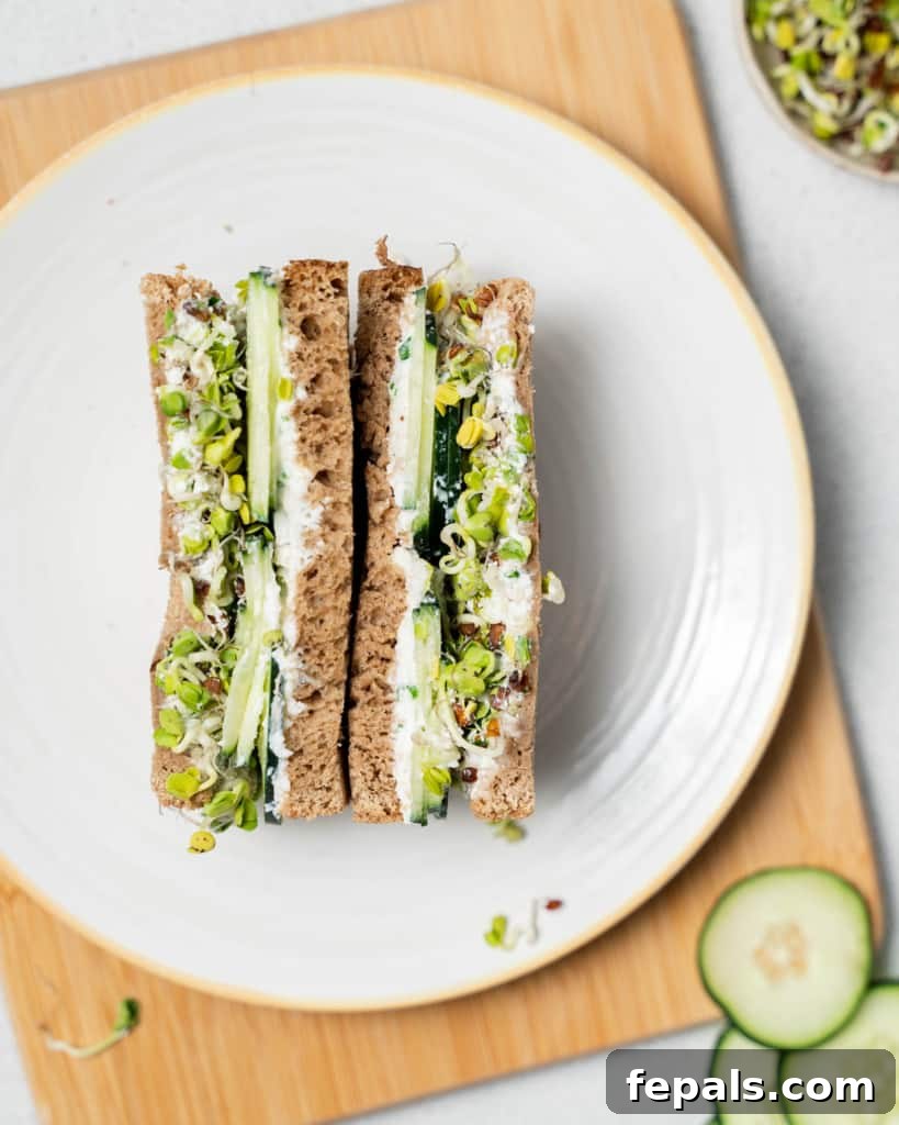 Elegant Cucumber Delights 16 top view of sandwich halves on a white plate over a brown cutting board