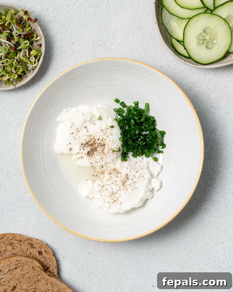 Elegant Cucumber Delights 5 Cream cheese, ricotta cheese, chives and lemon juice in a white bowl.