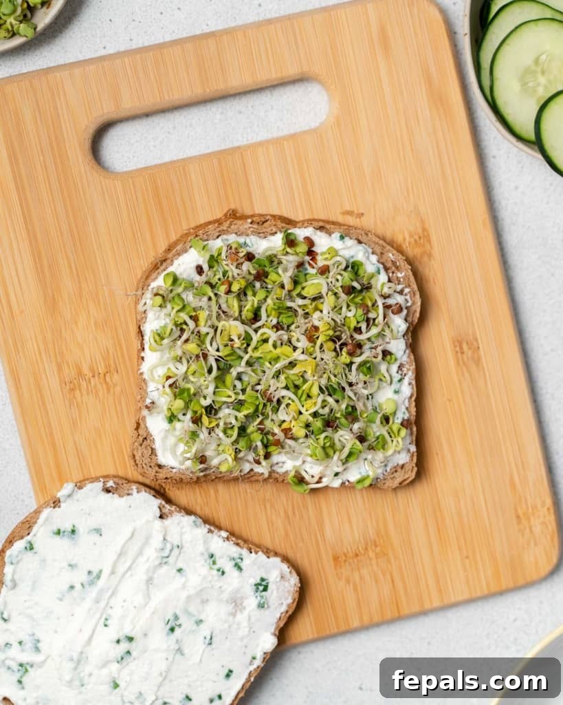 Elegant Cucumber Delights 8 Adding alfalfa sprouts to a sandwich.