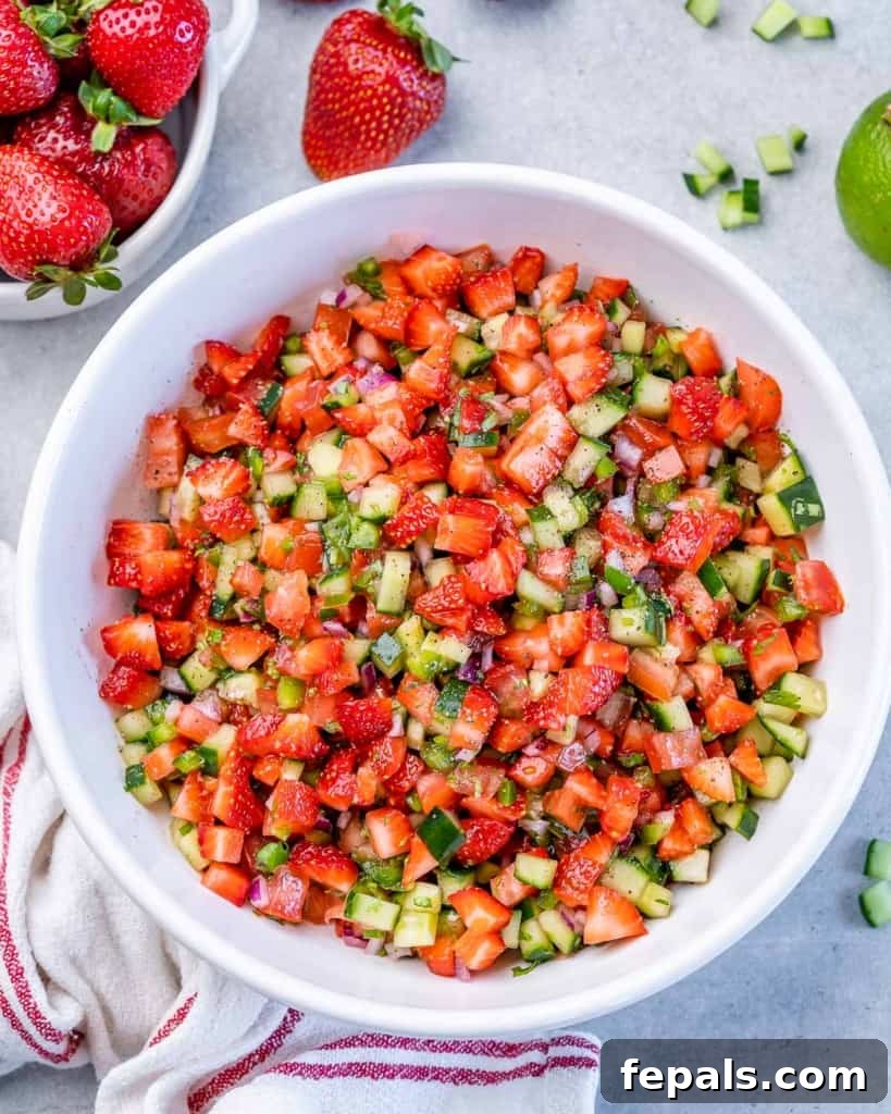 Top view of strawberry salsa in a round white bowl.