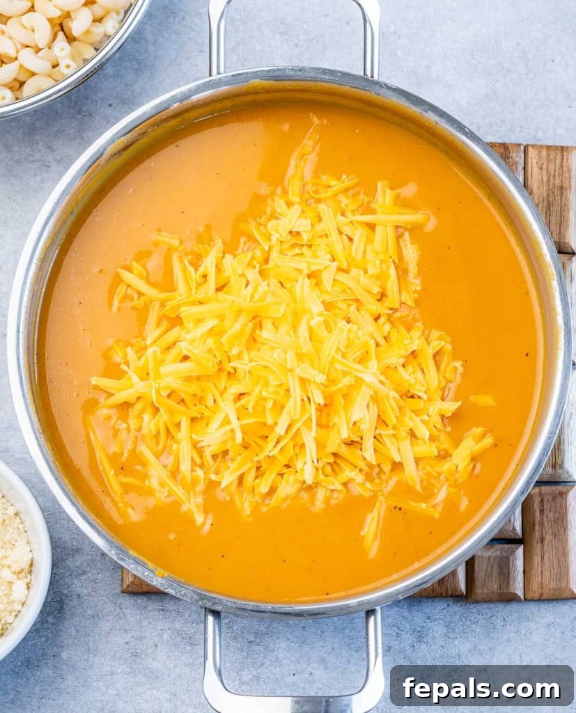 Roasted Pumpkin Mac and Cheese 6 Making cheese sauce in a large pot.