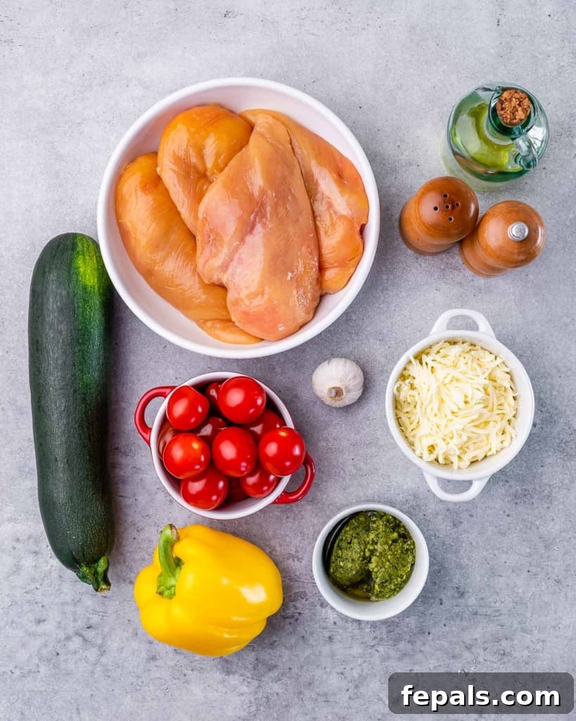 Pesto Perfection Chicken 4 ingredients to make pesto chicken in a skillet with zucchini and mozzarella