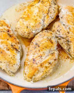 Chicken searing in a pan.