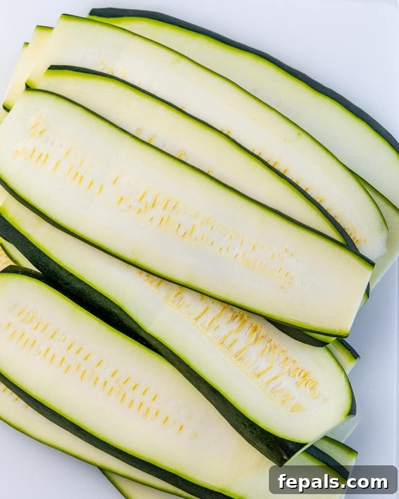 sliced zucchini thin to be baked for making enchilada roll ups 