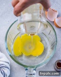 Combining oil with egg.