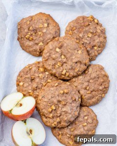 Top view of cookies on a sheet pan with sliced apple halves