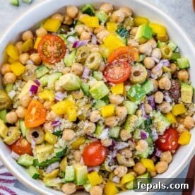 Mediterranean Chickpea Cucumber Quinoa Salad 12 Top view of quinoa and chickpea salad in a round white bowl, beautifully plated and ready to eat.