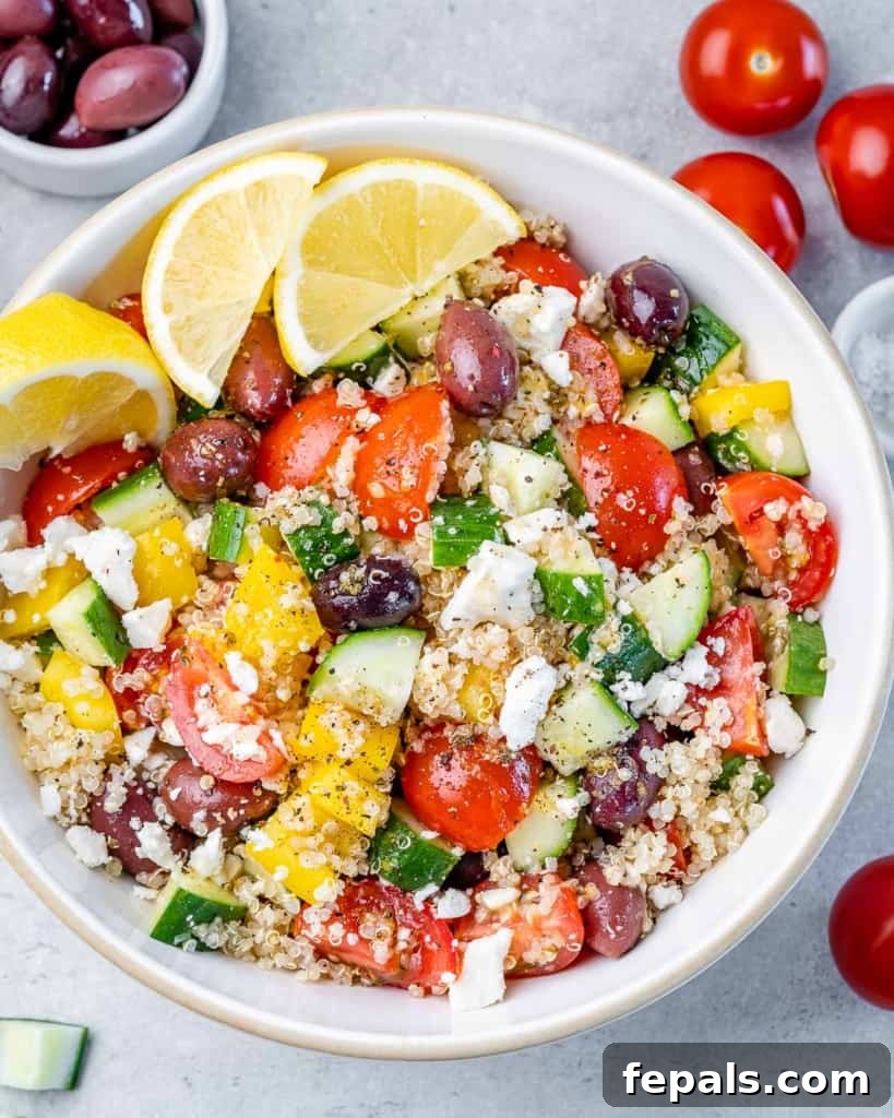 top view quinoa salad with olives and feta cheese in a white round bowl