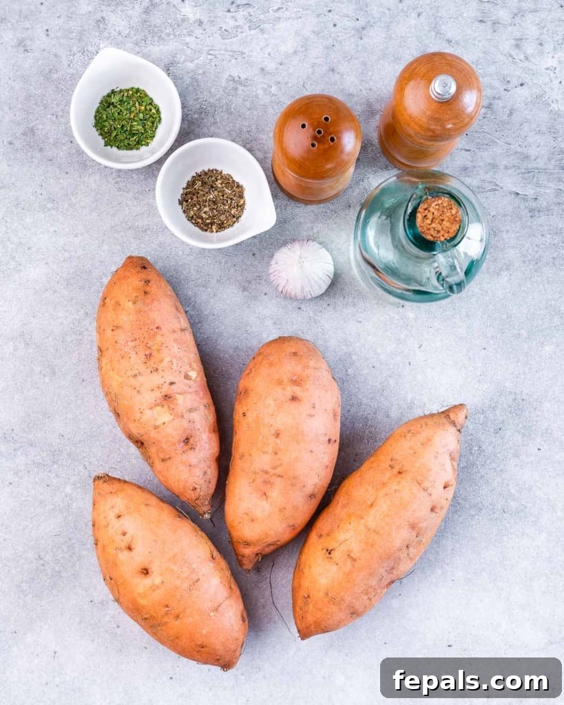 Golden Roasted Sweet Potato Smash 4 Arrangement of key ingredients for smashed sweet potatoes: whole sweet potatoes, a bottle of oil, fresh garlic cloves, and small bowls of dried herbs and spices.