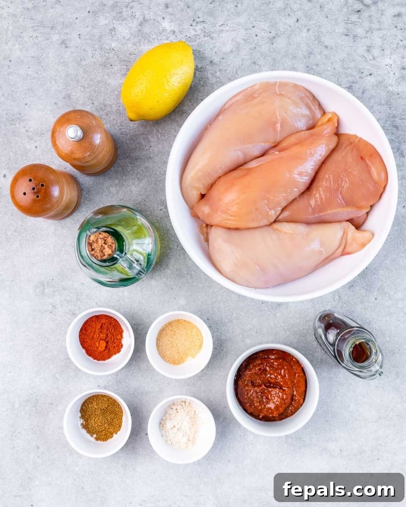 Spicy Harissa Roasted Chicken 4 ingredients to make baked harissa chicken laid out on a flat surface