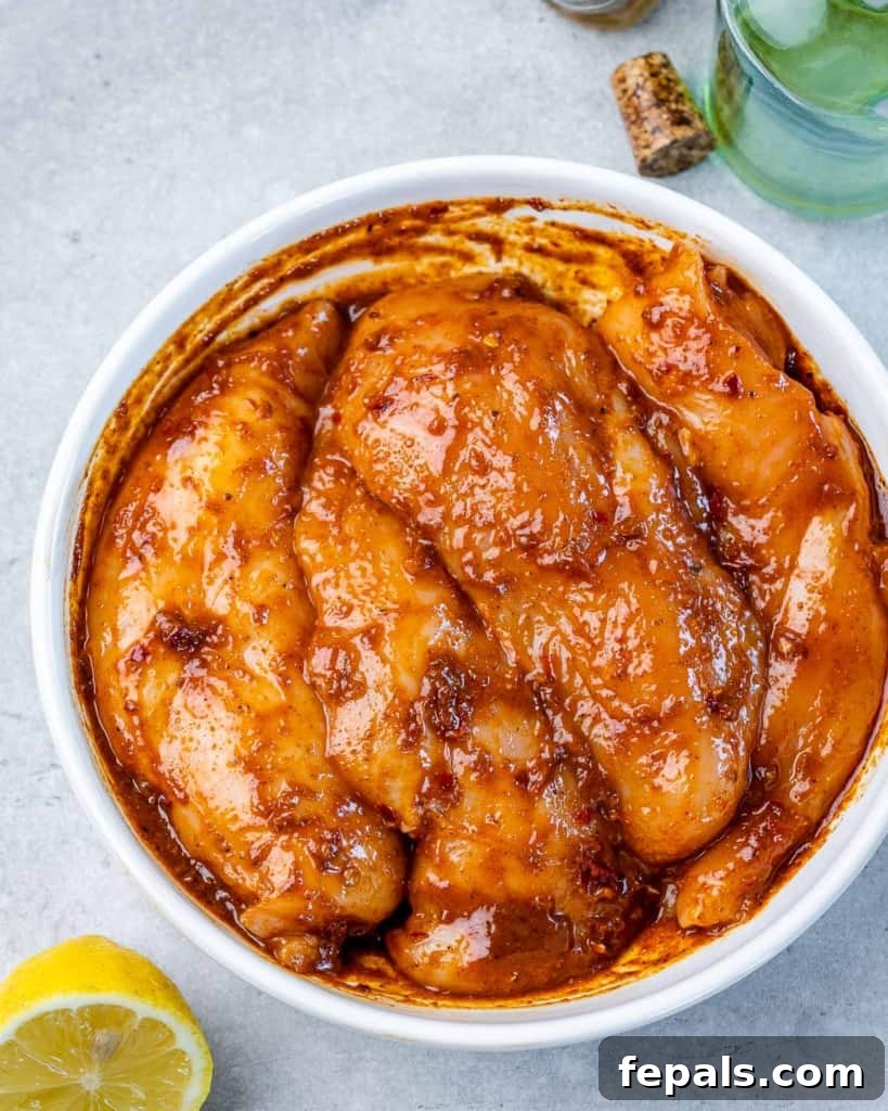 Spicy Harissa Roasted Chicken 7 uncooked chicken marinated in a round white plate