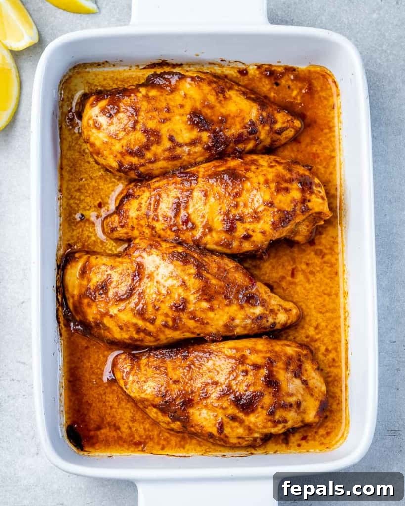 Spicy Harissa Roasted Chicken 8 top view of 4 baked harissa chicken breasts in a square baking dish