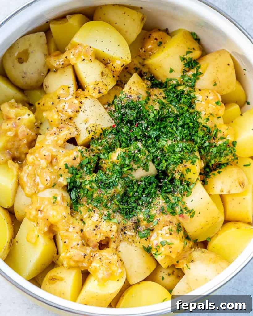 Hearty Warm German Potato Salad 6 Adding freshly chopped parsley to potato chunks.