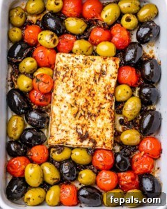 top view close up of baked feta cheese with olives and tomatoes