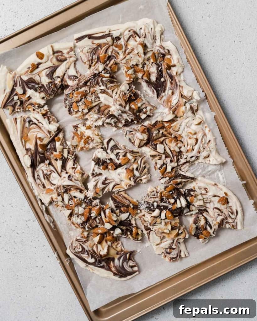 Peanut Butter Yogurt Frosty Bark 12 Pieces of peanut butter yogurt bark on a pan after being broken, ready for serving.