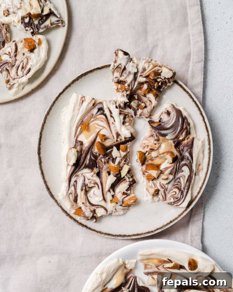 Peanut Butter Yogurt Frosty Bark 13 A top-down view of plates filled with slices of frozen yogurt bark, beautifully arranged.