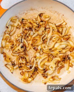 Velvet Pumpkin Risotto Easy Autumn Meal 10 Caramelizing onions in a skillet.