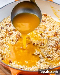 Velvet Pumpkin Risotto Easy Autumn Meal 12 Pouring pumpkin sauce into rice mixture.