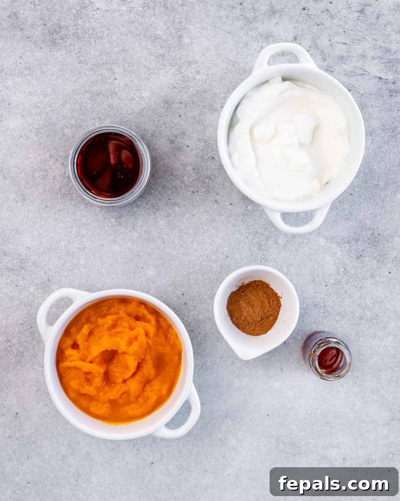 Pumpkin puree, Greek yogurt and spices in small bowls.