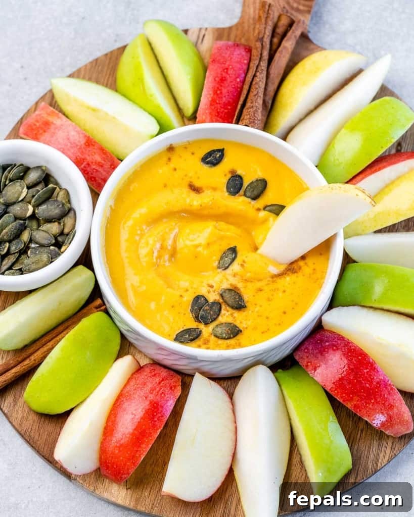 Apple slice in pumpkin dip.