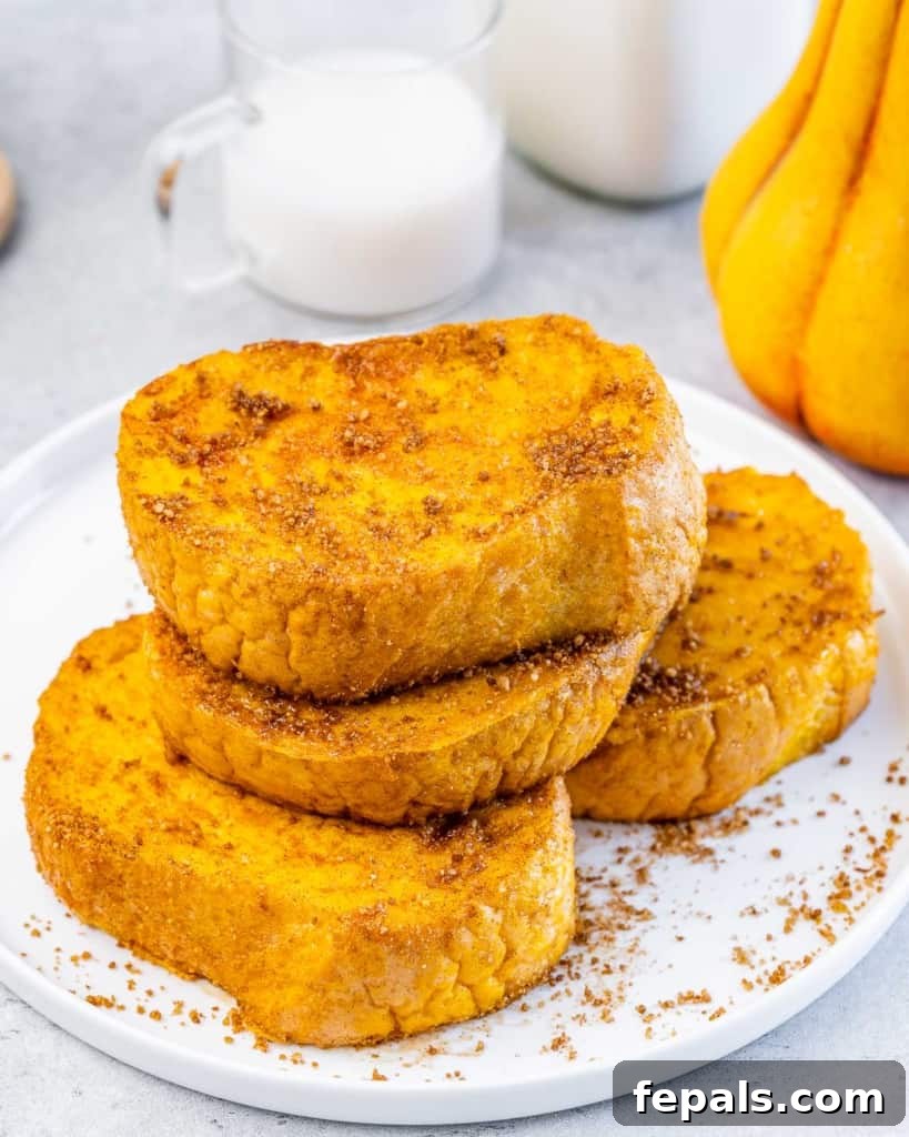 side shot of 4 pumpkin french toasts on a white plate 
