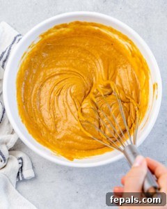 Stirring together batter for pumpkin bread.