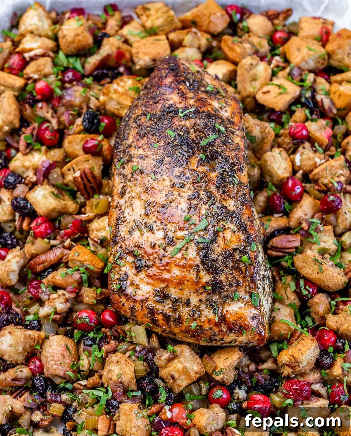 Golden Herb Roasted Sheet Pan Turkey Breast 3 Expertly seasoned turkey breast roasting alongside herb-infused stuffing on a sheet pan.