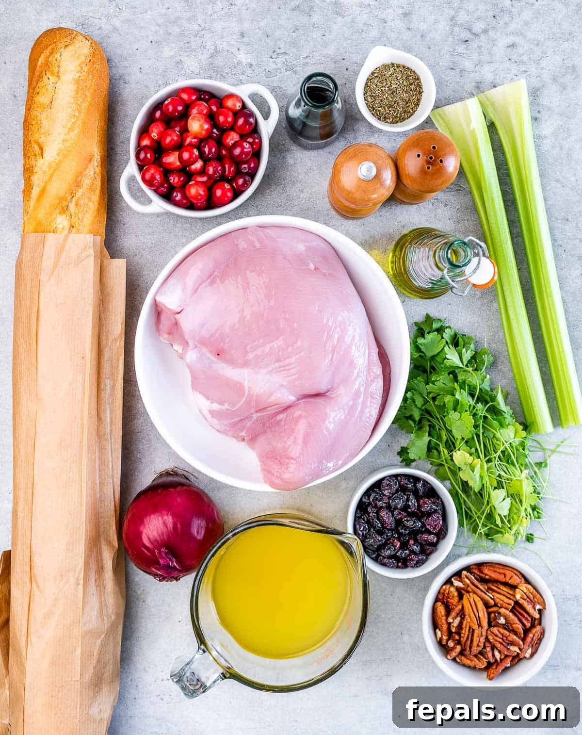 Golden Herb Roasted Sheet Pan Turkey Breast 4 All the raw ingredients laid out: turkey breast, baguette cubes, fresh and dried cranberries, assorted vegetables, herbs, and broth.