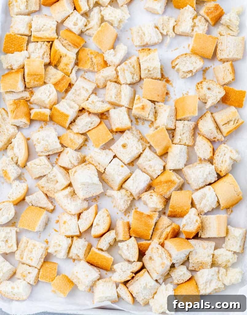 Golden Herb Roasted Sheet Pan Turkey Breast 5 Cubed bread spread out on a sheet pan for toasting.