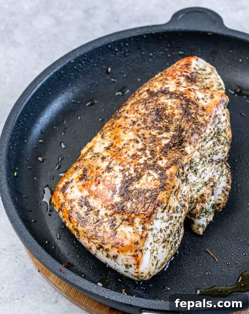 Golden Herb Roasted Sheet Pan Turkey Breast 8 Searing the turkey breast in a hot skillet to create a golden crust.