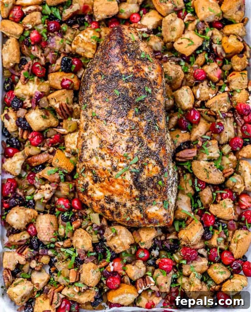 Golden Herb Roasted Sheet Pan Turkey Breast 9 A beautifully cooked turkey breast resting on a bed of golden-brown stuffing, ready to be served.