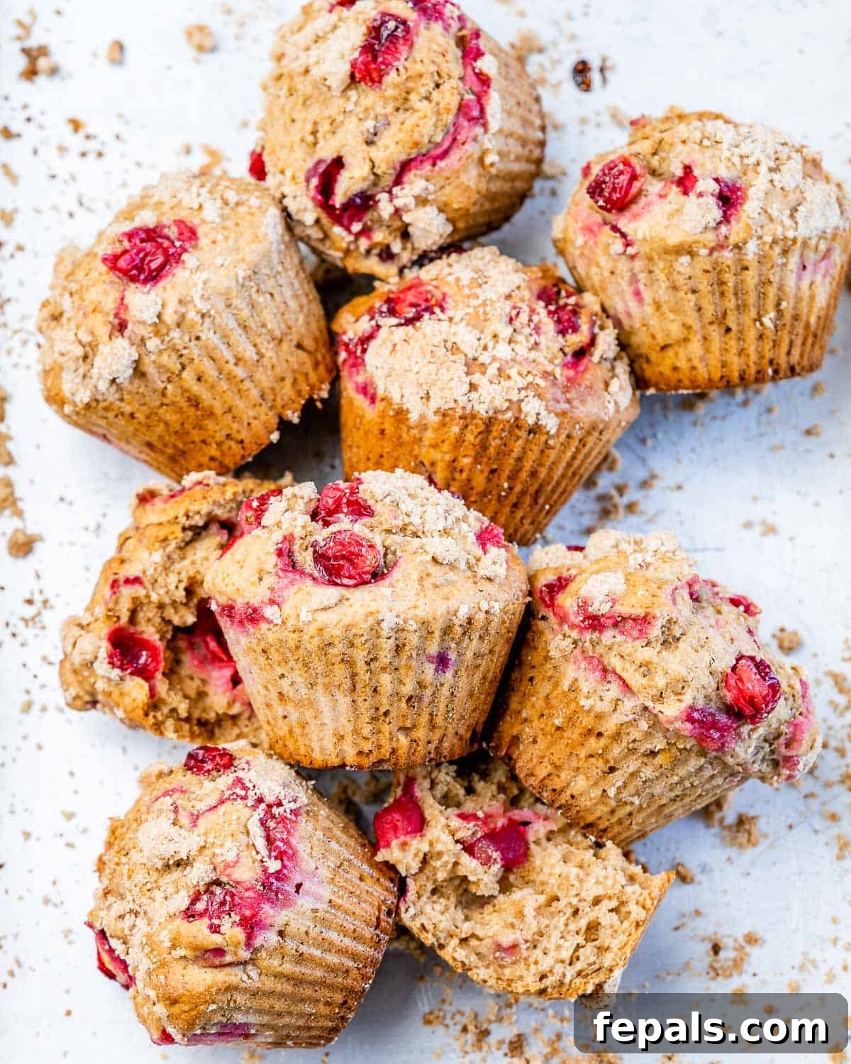 Wholesome Cranberry Orange Muffins 11 Muffins with cranberries on a white serving plate.