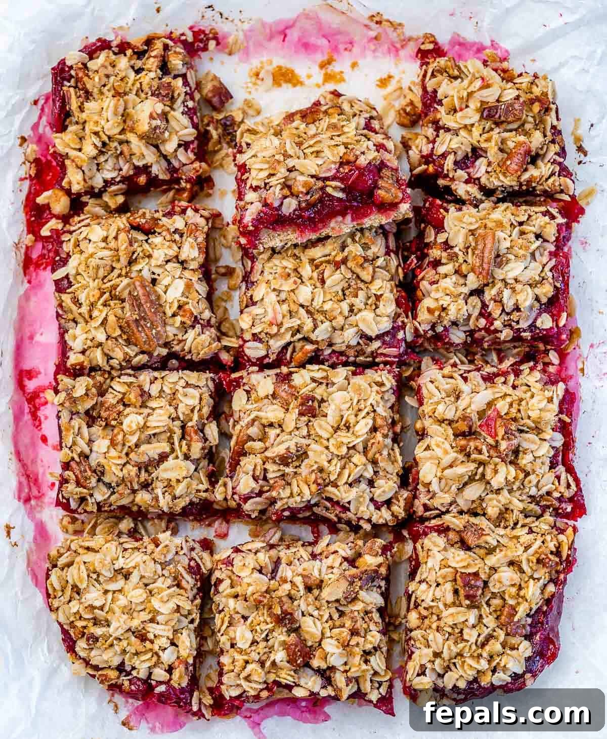 Cranberry bars cut into perfect squares in a baking pan, ready to be served.