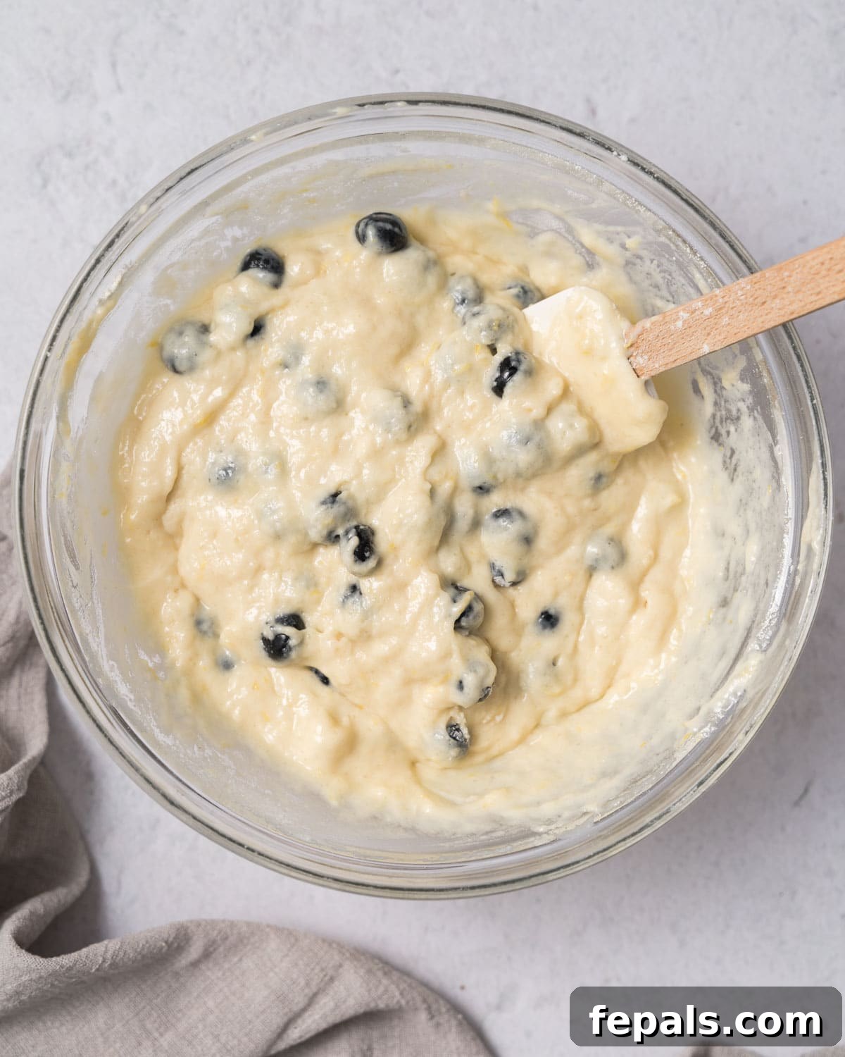 Zesty Blueberry Lemon Loaf 13 blueberries mixed with batter in a bowl