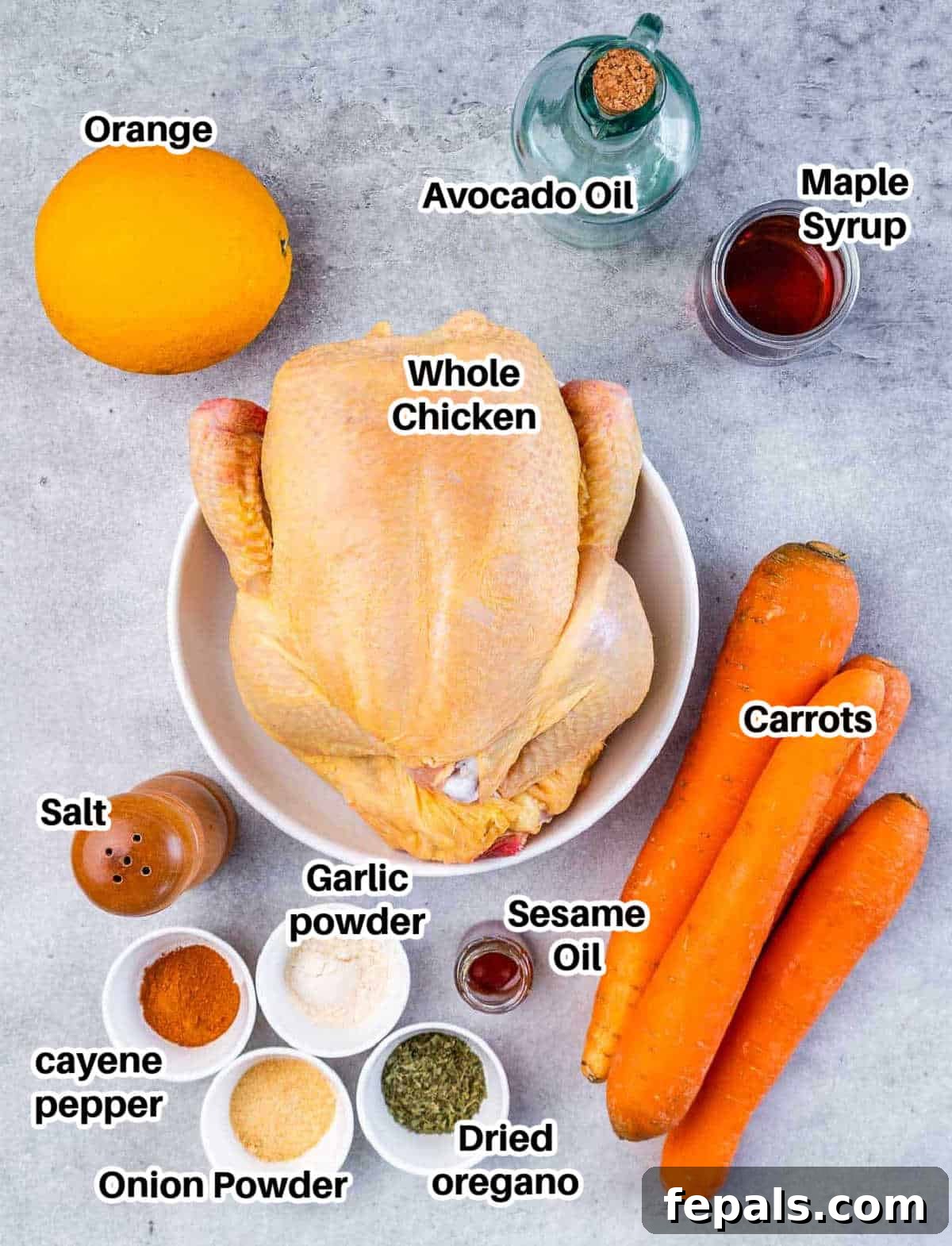 Maple-Kissed Roasted Whole Chicken 4 Various ingredients for baked chicken laid out, including a whole chicken, carrots, and spices.