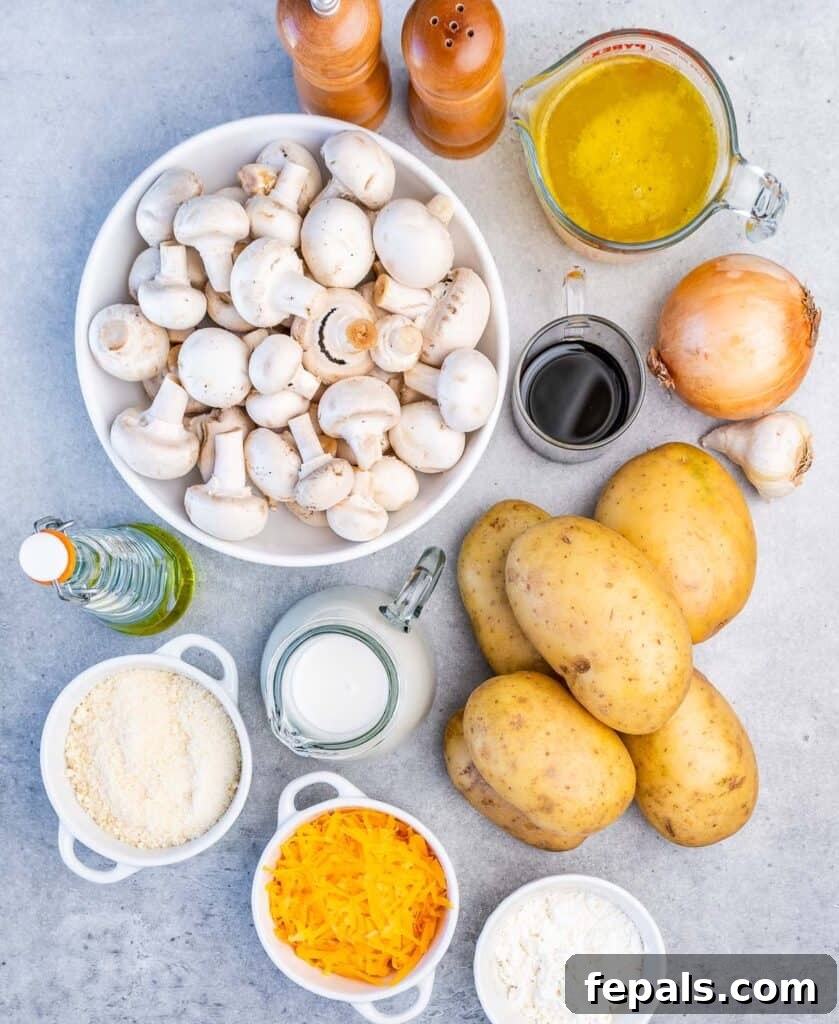 A flat lay photograph displaying all the fresh ingredients required to make the baked scalloped potato and mushroom casserole, neatly arranged.
