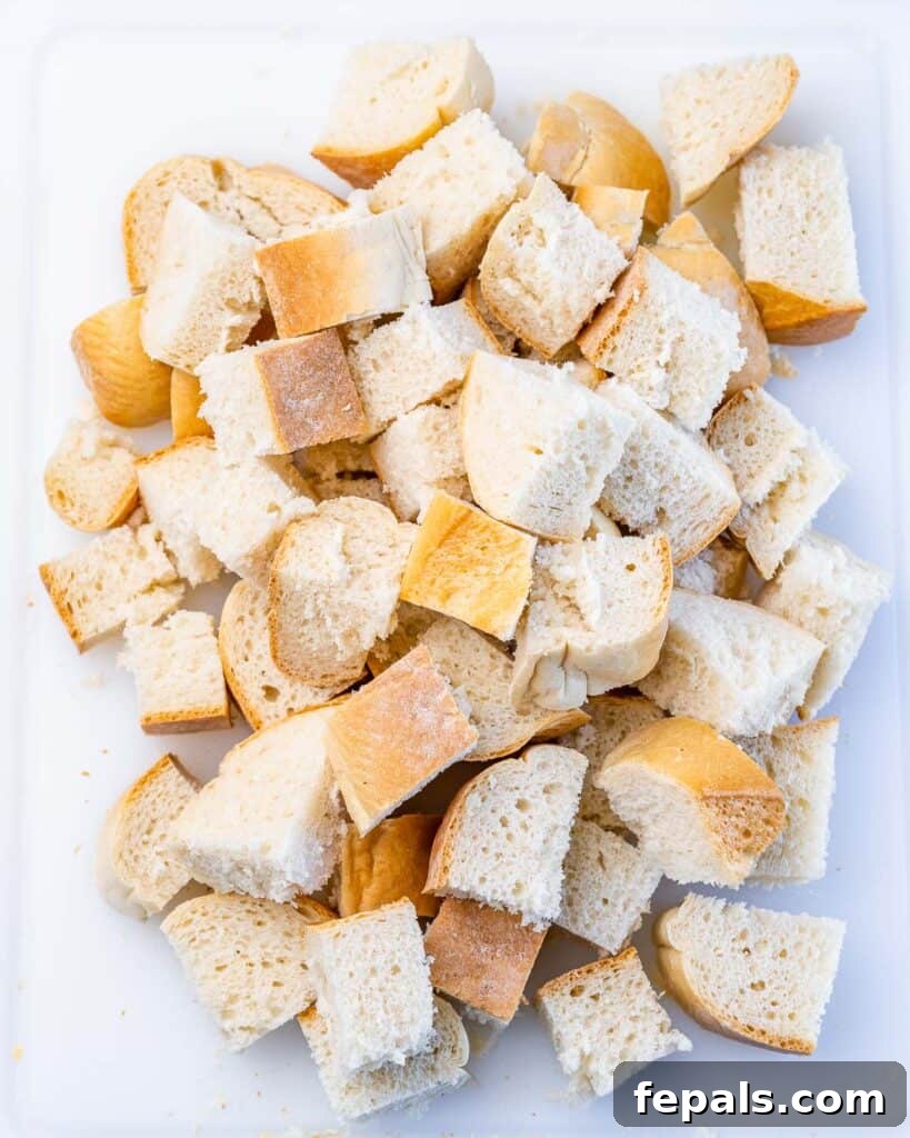 Cubed French bread spread in a baking dish.