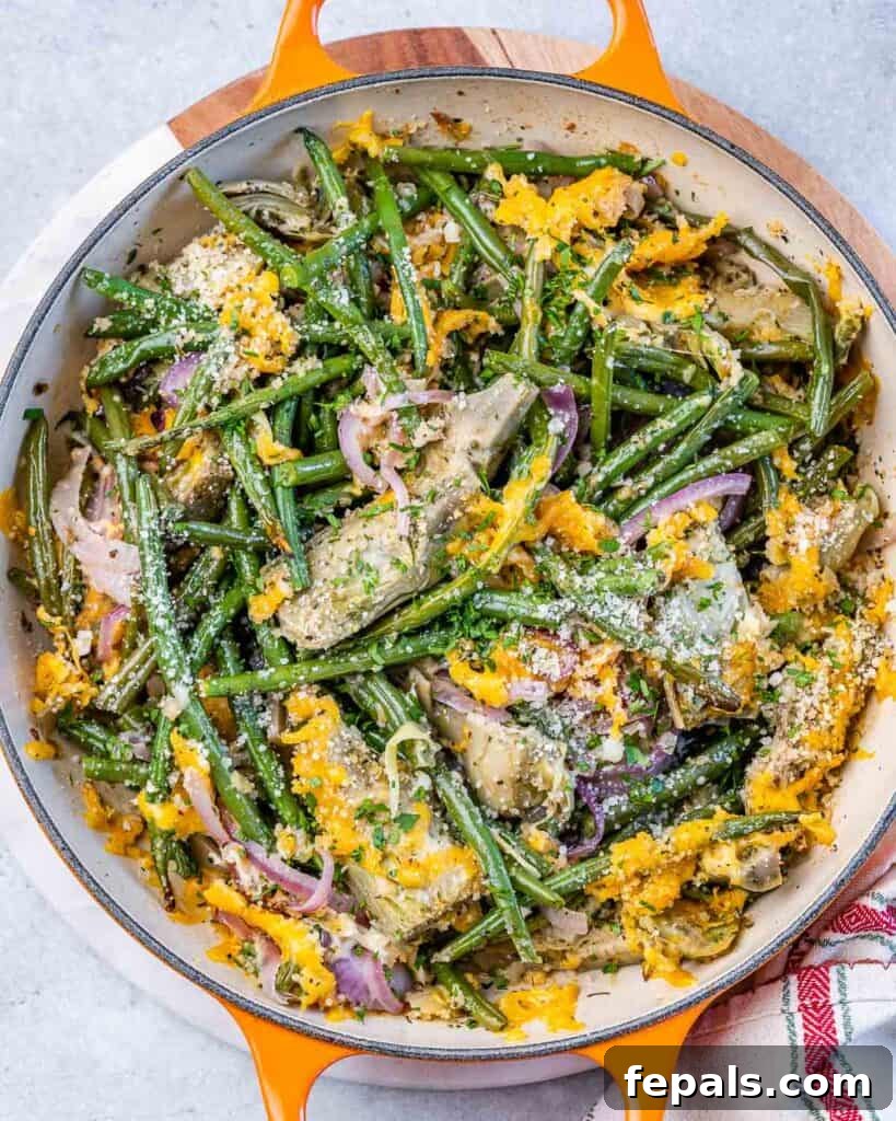 Mediterranean Artichoke Green Bean Bake 2 top view casserole of artichoke and green beans topped with shredded cheese