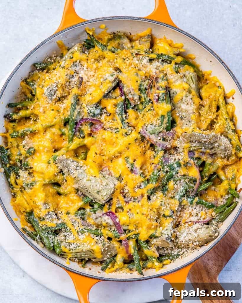Mediterranean Artichoke Green Bean Bake 11 top view of skillet with green beans and artichoke casserole topped with melted yellow cheddar cheese