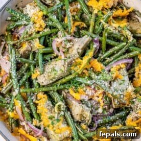 top view of green beans and artichoke casserole topped with melted yellow cheese