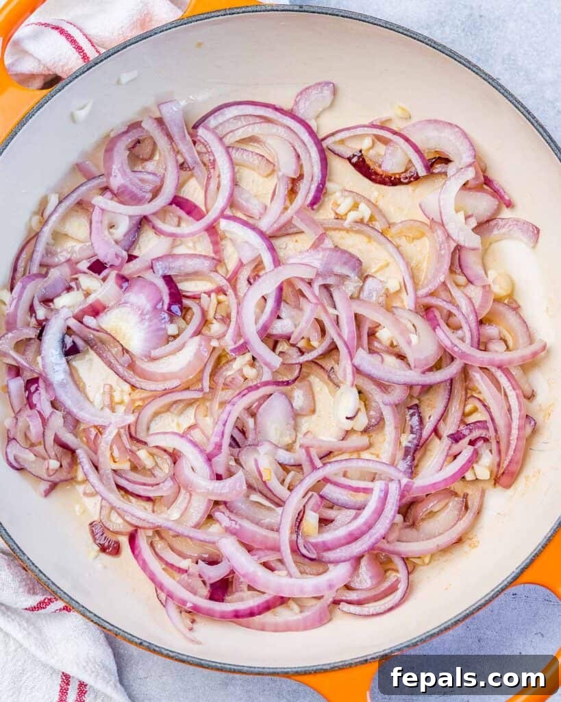 Mediterranean Artichoke Green Bean Bake 6 sauteed red onions on a skillet