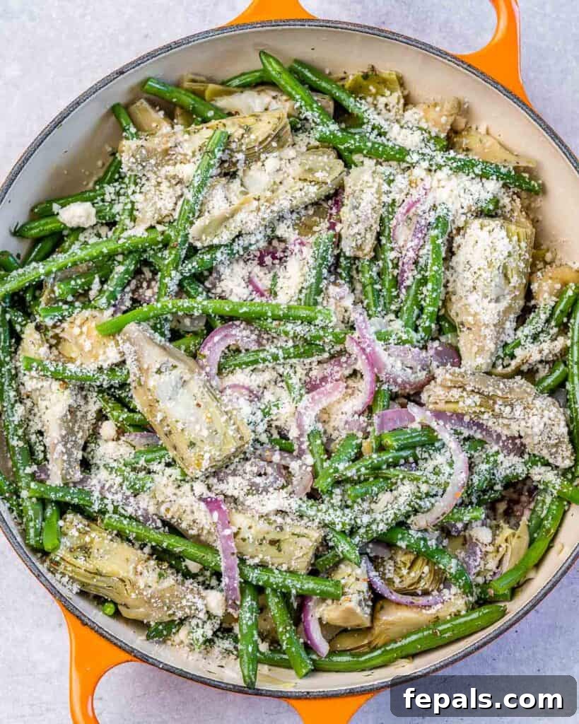 Mediterranean Artichoke Green Bean Bake 8 breadcrumbs and cheese added over the skillet of green beans and artichoke mix with onions and garlic