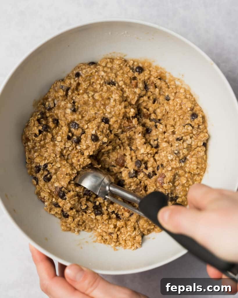 Wholesome Western Wonders 13 Scooping cookie dough out of a bowl for Healthy Cowboy Cookies.
